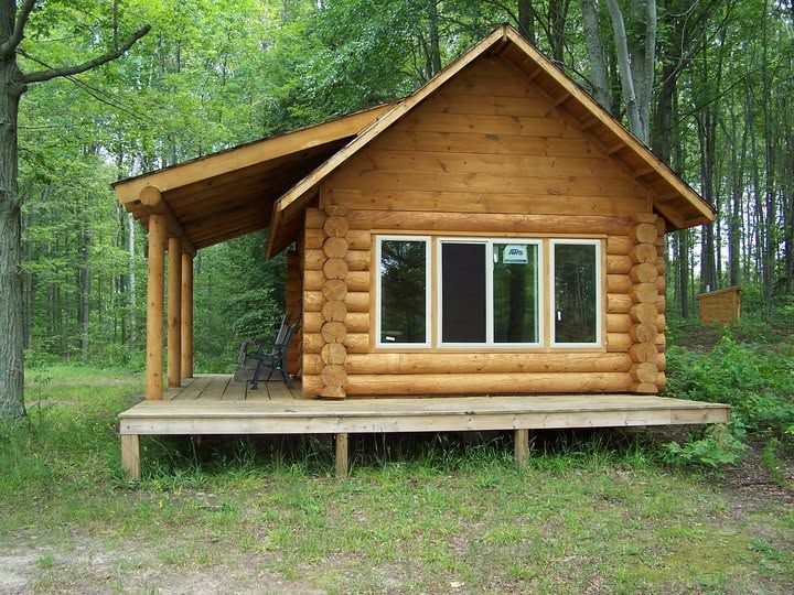 Finished Beaver Log Homes small log cabin with a shingled roof and covered entry