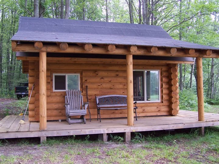 Finished Beaver Log Homes small log cabin with a deep covered porch
